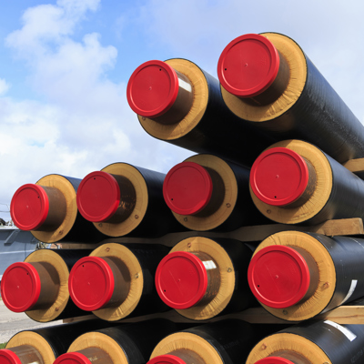 Een voorraad gestapelde warmtenet buizen om te gebruiken voor het duurzaam verwarmen van gebouwen.